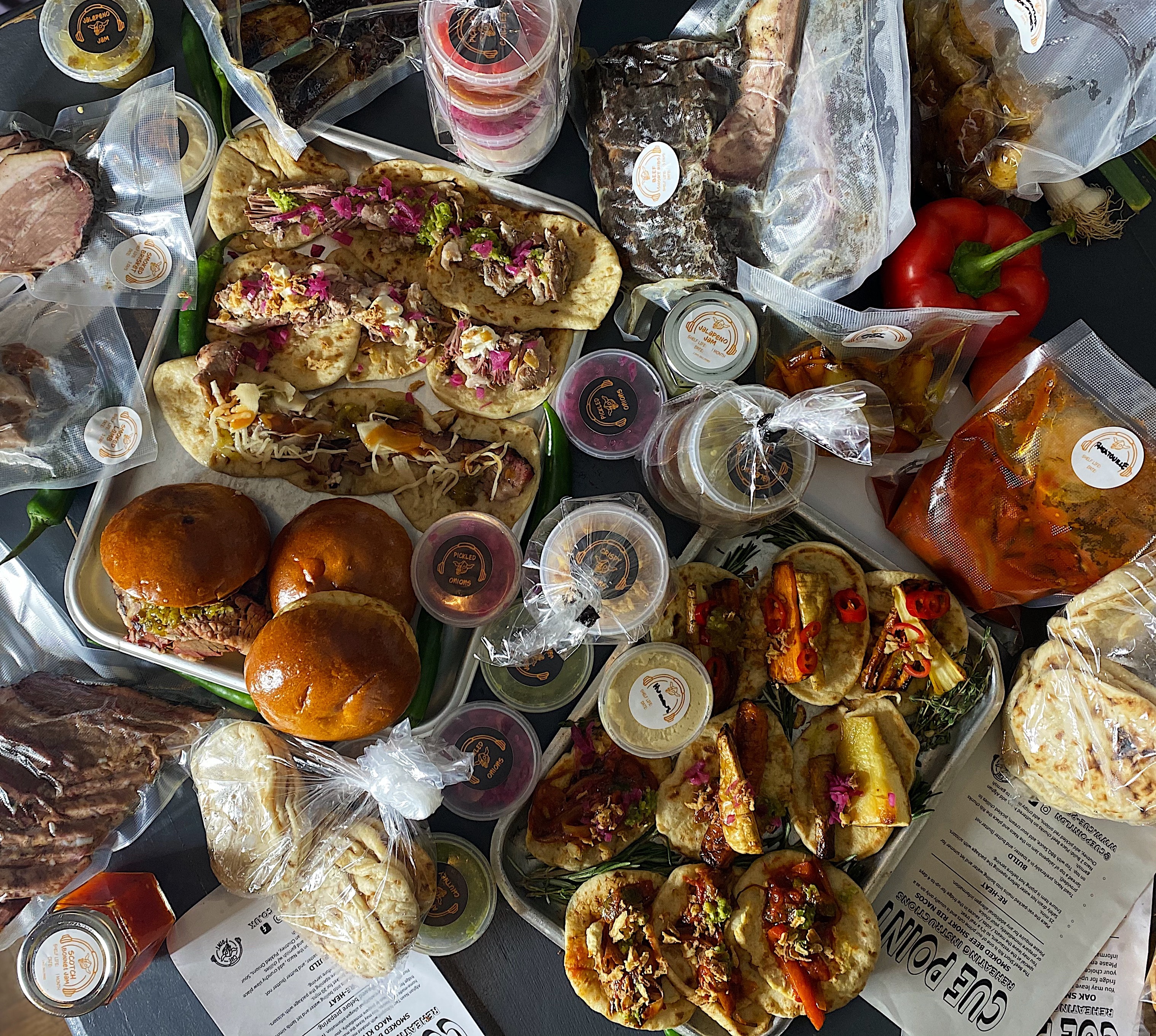 Cue Point at-home kit spread with Nacos, burgers and condiments